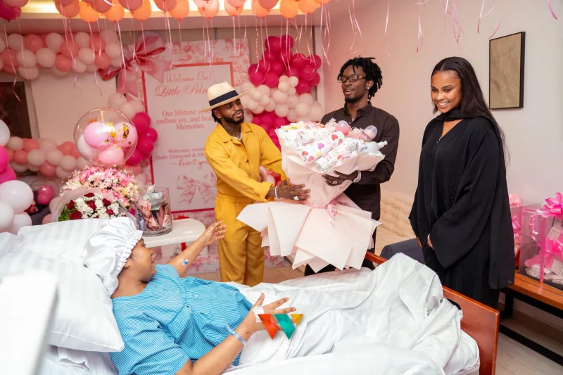 Diamond Platnumz and Zuchu in a hospital room holding their newborn baby girl